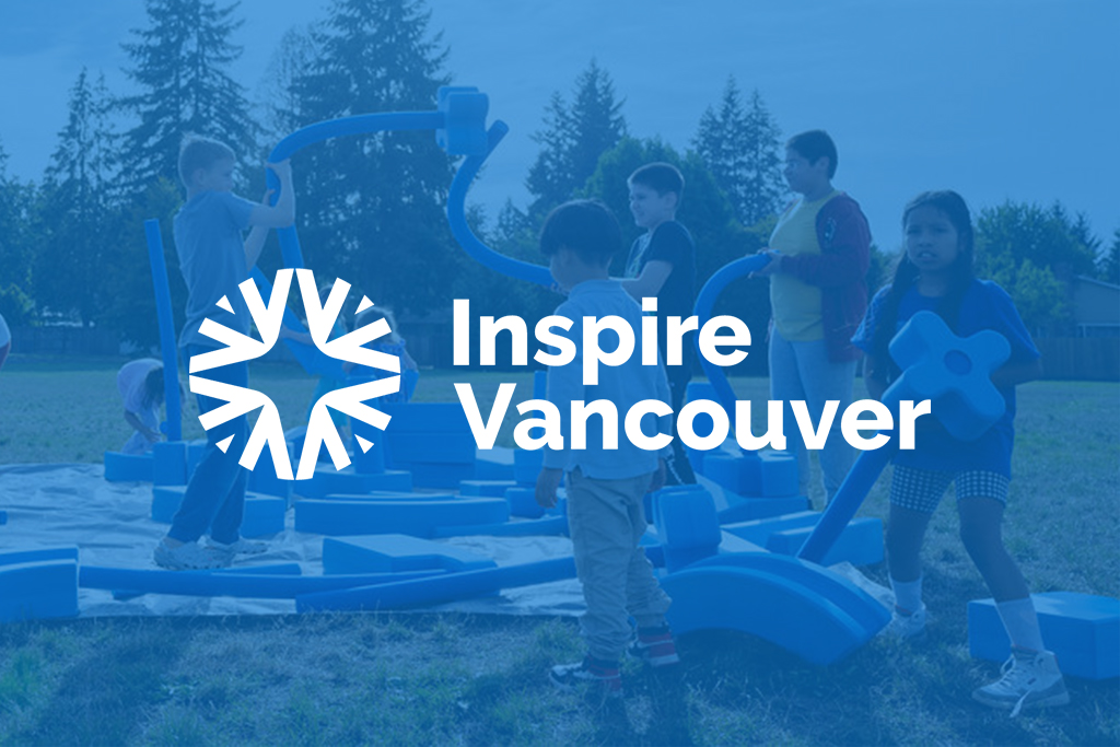 Children building with large blocks in a park with a blue color overlay and white Inspire Vancouver logo